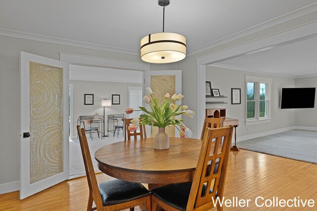 9090 E 32nd Rd, Cadillac, MI 49601 - dining space featuring baseboards, ornamental molding, and light wood finished floors