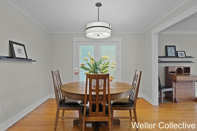 9090 E 32nd Rd, Cadillac, MI 49601 - dining room with light wood-type flooring, baseboards, and crown molding