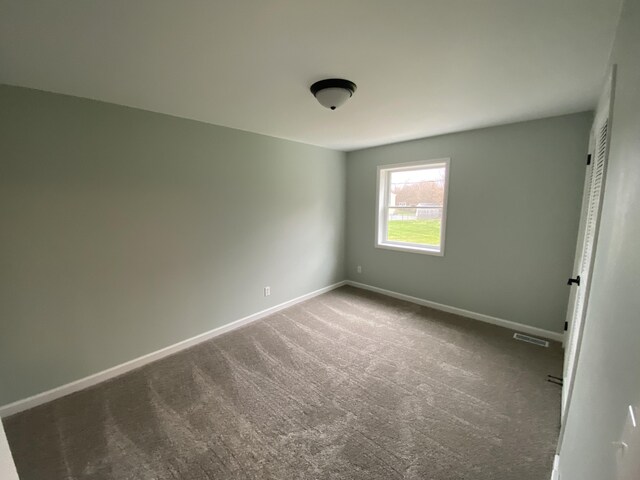 10 Meadow Hills Ln, Fremont, MI 49412 - unfurnished bedroom featuring baseboards, visible vents, and carpet flooring