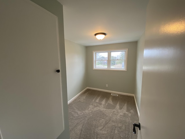 10 Meadow Hills Ln, Fremont, MI 49412 - spare room featuring visible vents, baseboards, and carpet flooring