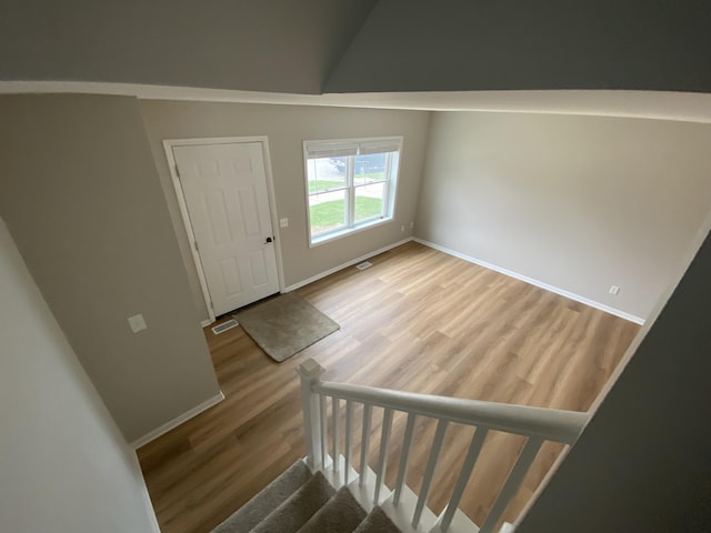 10 Meadow Hills Ln, Fremont, MI 49412 - entryway featuring visible vents, wood finished floors, baseboards, and stairs