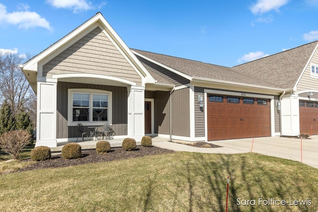 6501 Andres Xing Unit 14, Grandville, MI 49418 - single story home featuring roof with shingles, a front lawn, concrete driveway, covered porch, and an attached garage