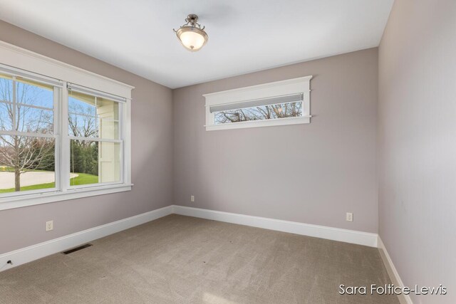 6501 Andres Xing Unit 14, Grandville, MI 49418 - carpeted spare room with baseboards and visible vents