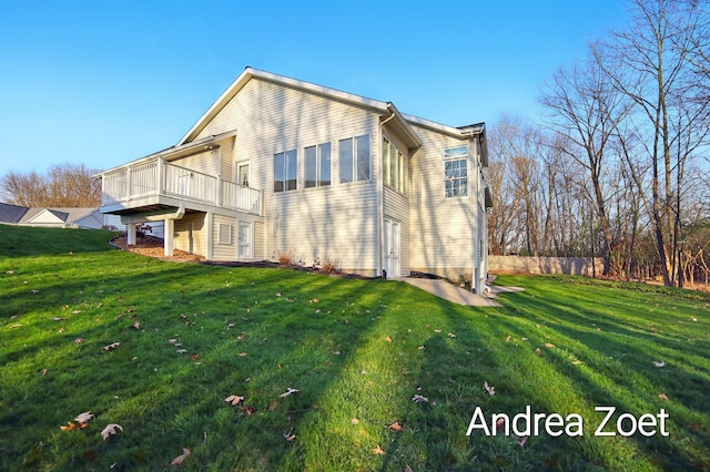 back of house featuring a lawn, a wooden deck, and fence