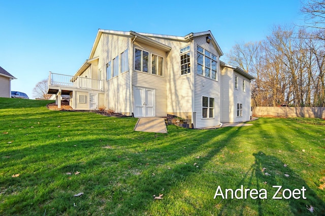 rear view of property with a lawn and a deck