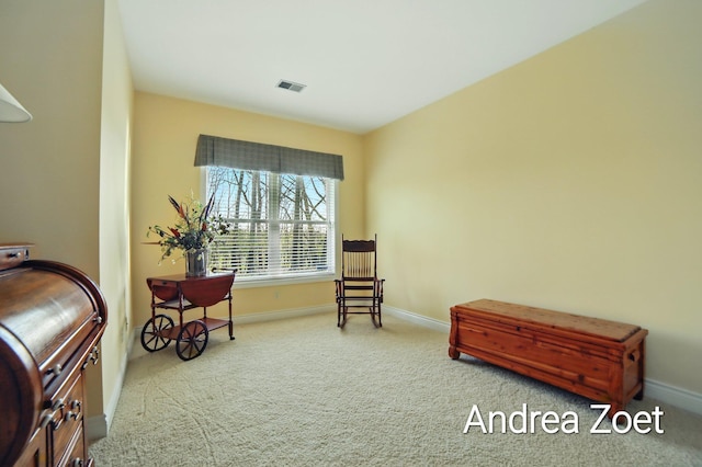 sitting room with visible vents, baseboards, and carpet floors