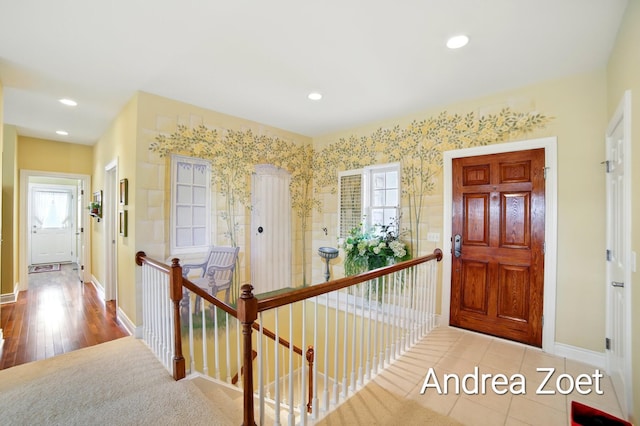 corridor with an upstairs landing, a healthy amount of sunlight, recessed lighting, and baseboards
