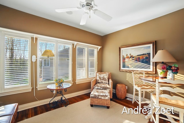 sitting room featuring ceiling fan, wood finished floors, and baseboards