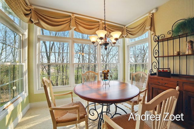 sunroom / solarium with plenty of natural light, a notable chandelier, carpet floors, and baseboards