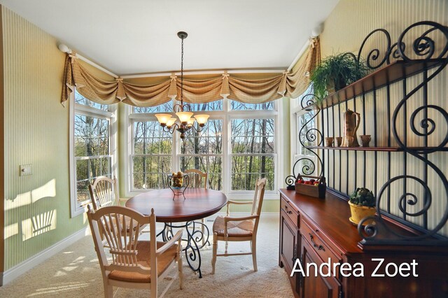 dining area featuring a chandelier, carpet flooring, and baseboards