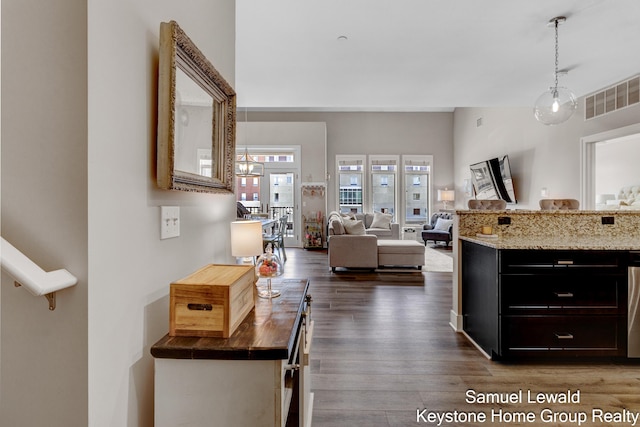 430 Union Ave NE Unit 303, Grand Rapids, MI 49503 - interior space featuring dark wood finished floors, dark cabinets, hanging light fixtures, and visible vents