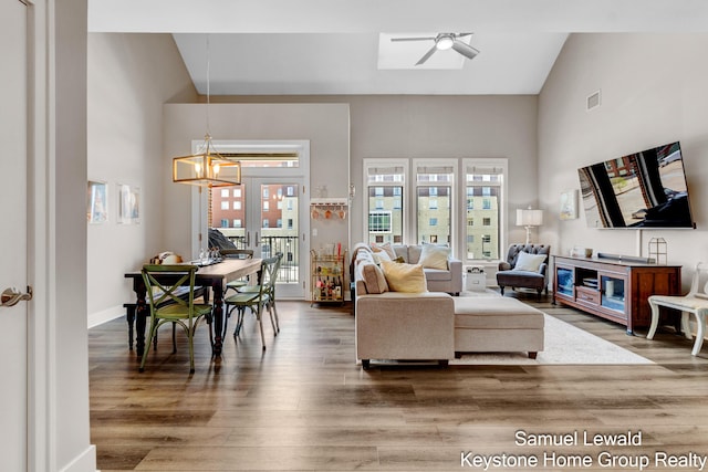 430 Union Ave NE Unit 303, Grand Rapids, MI 49503 - living area with visible vents, baseboards, a ceiling fan, wood finished floors, and high vaulted ceiling