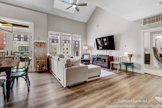 430 Union Ave NE Unit 303, Grand Rapids, MI 49503 - living room with light wood-style flooring, a wealth of natural light, visible vents, ceiling fan, and high vaulted ceiling