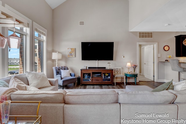 430 Union Ave NE Unit 303, Grand Rapids, MI 49503 - living room featuring baseboards, wood finished floors, visible vents, and high vaulted ceiling