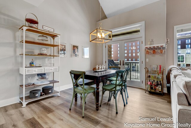 430 Union Ave NE Unit 303, Grand Rapids, MI 49503 - dining area featuring plenty of natural light, vaulted ceiling, an inviting chandelier, and light wood-style floors