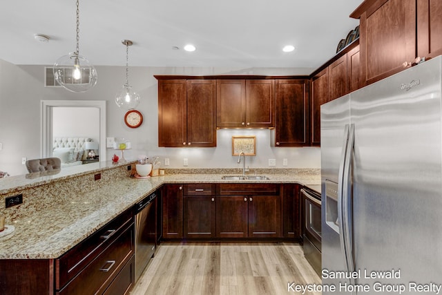 430 Union Ave NE Unit 303, Grand Rapids, MI 49503 - kitchen with light wood finished floors, stainless steel appliances, a sink, light stone countertops, and a peninsula