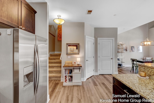 430 Union Ave NE Unit 303, Grand Rapids, MI 49503 - kitchen with light wood finished floors, stainless steel fridge with ice dispenser, decorative light fixtures, light stone countertops, and baseboards