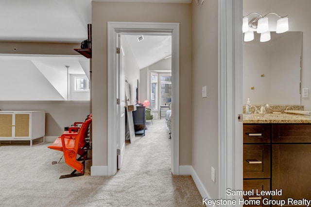 430 Union Ave NE Unit 303, Grand Rapids, MI 49503 - corridor featuring lofted ceiling, carpet flooring, baseboards, and a sink