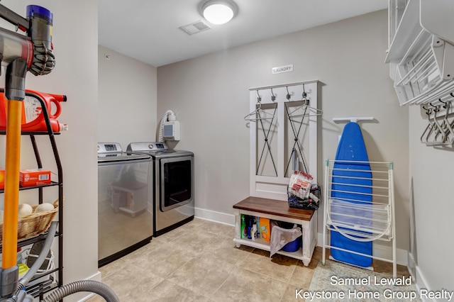 430 Union Ave NE Unit 303, Grand Rapids, MI 49503 - laundry room featuring separate washer and dryer, baseboards, visible vents, and laundry area