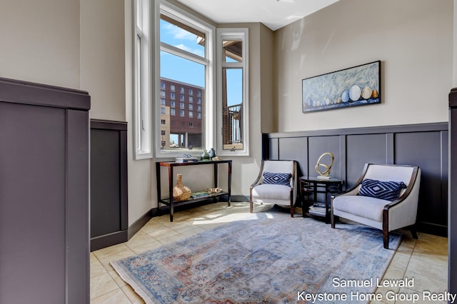 430 Union Ave NE Unit 303, Grand Rapids, MI 49503 - sitting room featuring wainscoting, a decorative wall, and tile patterned flooring