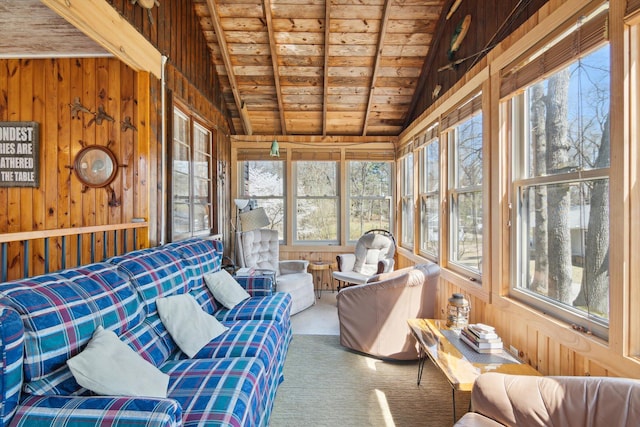 sunroom featuring vaulted ceiling with beams, wooden ceiling, wooden walls, and carpet