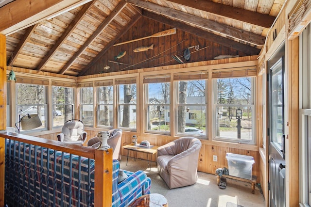 sunroom / solarium with wood ceiling, lofted ceiling with beams, and wood walls