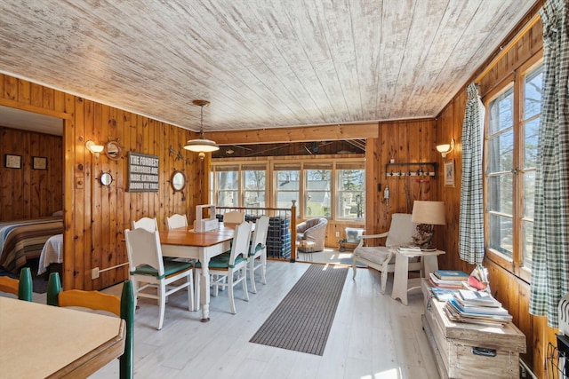 dining area featuring wood ceiling, wood walls, and a wealth of natural light