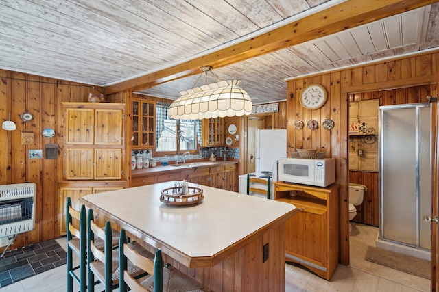 kitchen featuring a sink, heating unit, wood walls, white appliances, and wood ceiling
