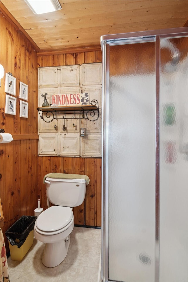 full bath featuring toilet, wood walls, tile patterned flooring, a shower stall, and wooden ceiling