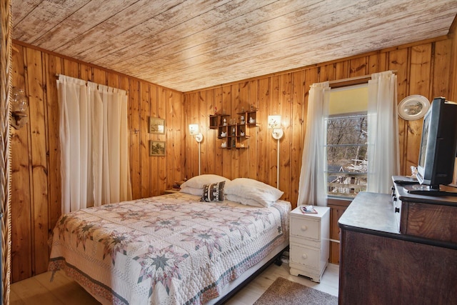 bedroom featuring wooden ceiling and wooden walls