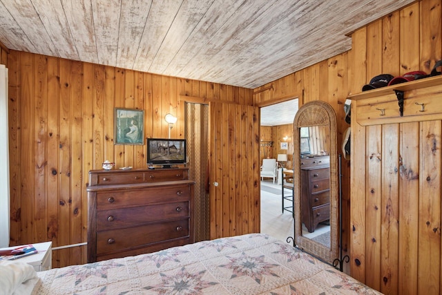 bedroom featuring wood ceiling and wooden walls