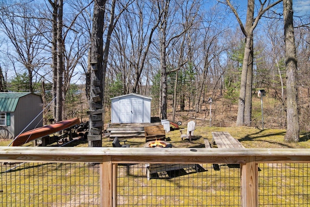 wooden terrace featuring an outbuilding and a storage shed