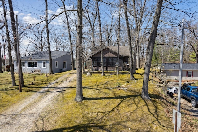 view of yard with dirt driveway