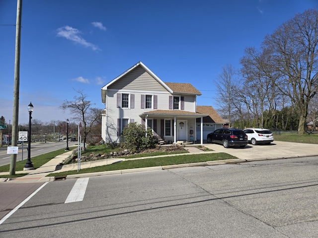 101 N Lewis St, Saline, MI 48176 - traditional home featuring a shingled roof and concrete driveway