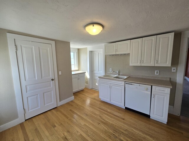 101 N Lewis St, Saline, MI 48176 - kitchen featuring white cabinets, white dishwasher, a sink, and light wood-style flooring