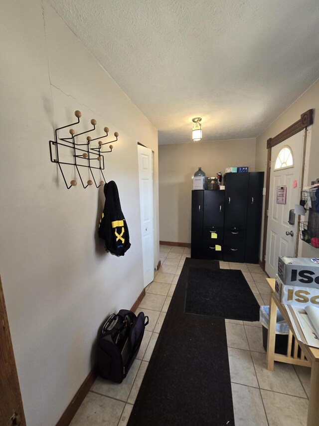 101 N Lewis St, Saline, MI 48176 - interior space featuring light tile patterned flooring, a textured ceiling, and baseboards