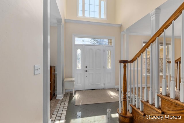 7174 Loma Linda Dr, Rockford, MI 49341 - entryway featuring tile patterned flooring, a high ceiling, baseboards, and stairs