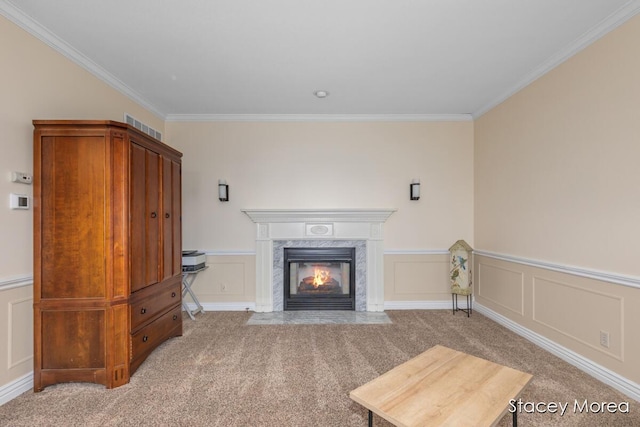 7174 Loma Linda Dr, Rockford, MI 49341 - unfurnished living room featuring crown molding, light carpet, a premium fireplace, a decorative wall, and wainscoting