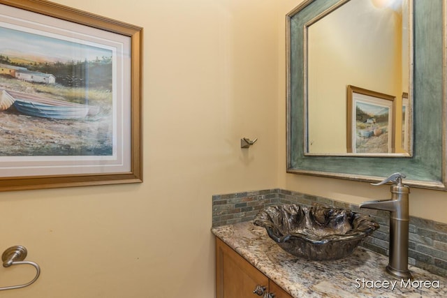 7174 Loma Linda Dr, Rockford, MI 49341 - bathroom featuring vanity and tasteful backsplash