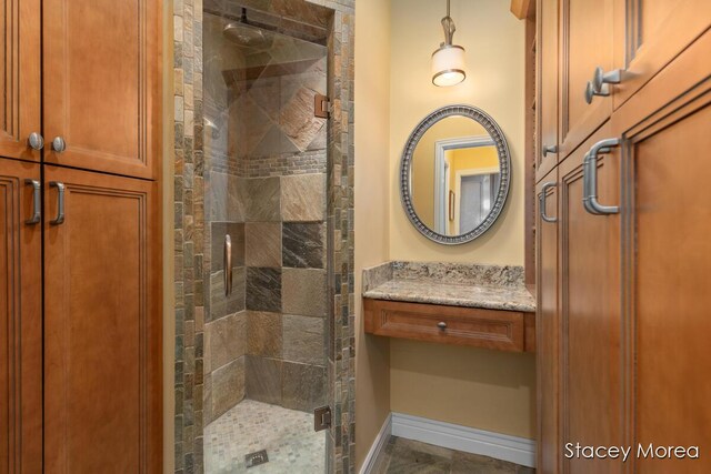 7174 Loma Linda Dr, Rockford, MI 49341 - bathroom featuring a shower stall, baseboards, and vanity