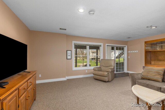 7174 Loma Linda Dr, Rockford, MI 49341 - living area with baseboards, light colored carpet, and recessed lighting