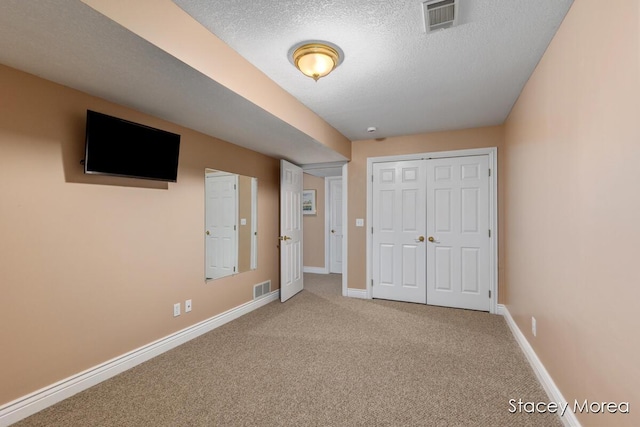 7174 Loma Linda Dr, Rockford, MI 49341 - unfurnished bedroom featuring carpet, baseboards, a textured ceiling, and a closet