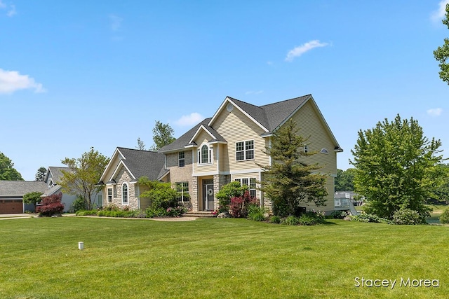 7174 Loma Linda Dr, Rockford, MI 49341 - traditional-style house with a front lawn and stone siding
