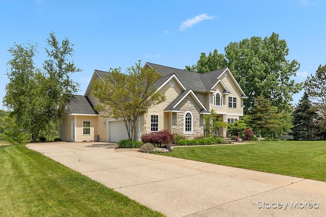 7174 Loma Linda Dr, Rockford, MI 49341 - view of front of house featuring an attached garage, driveway, a front yard, and stone siding