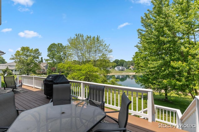 7174 Loma Linda Dr, Rockford, MI 49341 - wooden terrace with outdoor dining space, area for grilling, and a water view