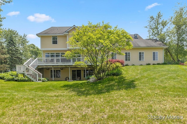 7174 Loma Linda Dr, Rockford, MI 49341 - rear view of house with stairs, a wooden deck, and a lawn