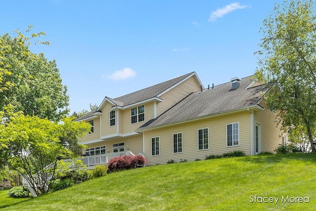 7174 Loma Linda Dr, Rockford, MI 49341 - back of house featuring a lawn, a wooden deck, a shingled roof, and a chimney