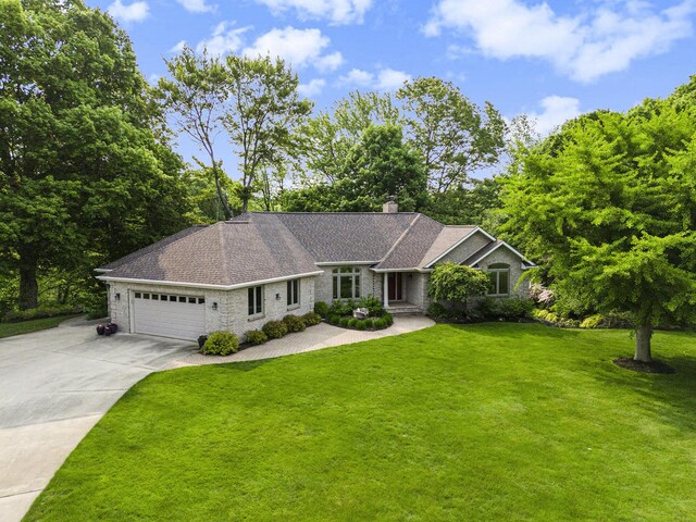565 Hawksnest Dr, South Haven, MI 49090 - ranch-style home featuring a chimney, a front lawn, a garage, driveway, and stone siding