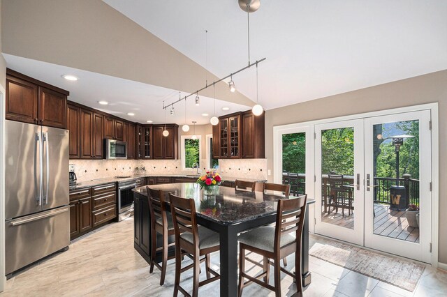 565 Hawksnest Dr, South Haven, MI 49090 - kitchen with stainless steel appliances, a sink, dark brown cabinets, tasteful backsplash, and french doors