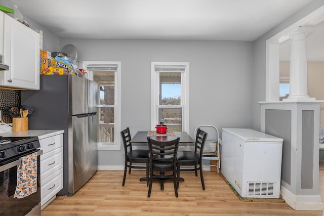 442 Emerald Ave NE, Grand Rapids, MI 49503 - interior space with light wood-style floors, baseboards, and decorative columns